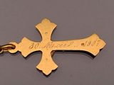 an image of a gold cross with a chain attached to it