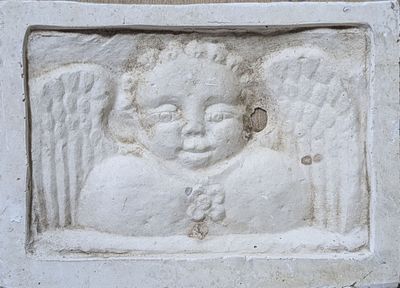 a small statue of an angel on a wall