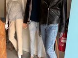 trois mannequins dans une pièce où sont exposés des vêtements