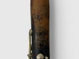 a very old saxophone that is on display on the wall