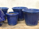 many blue vases and vases on a wooden table