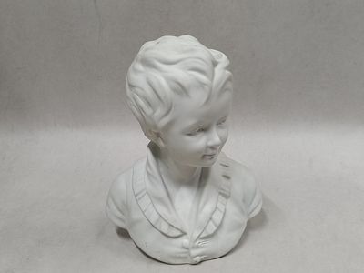 a white busturine of a boy wearing a suit and tie