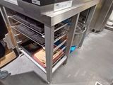 a microwave that is sitting on a cart in the kitchen