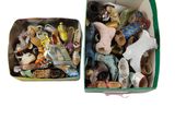 two boxes filled with different types of figurines in them