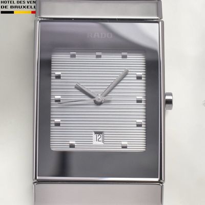 a close up of a watch on a white surface
