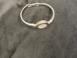 silver and gold bang bracelet with a gold plated clasp