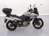 a silver motorcycle that is parked in a white room