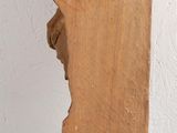 a piece of wood hanging from a hook on a wall