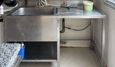 a kitchen with a sink and a counter in it