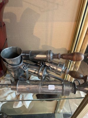 a glass shelf with a bunch of metal items on it