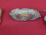 three pieces of silver on a red surface