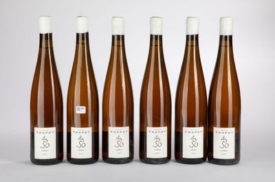 six bottles of wine are lined up in a row on a table