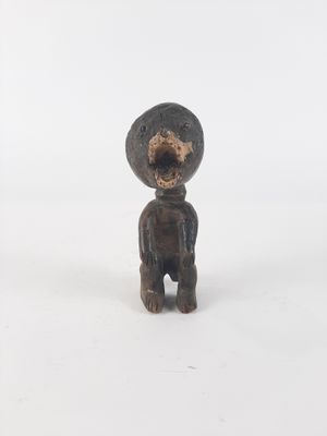 a small figurine of a bear with a hat on
