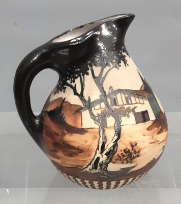 a black and white vase with a painting on it