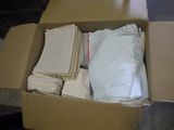 une boîte en carton remplie d'une grande quantité de serviettes pliées