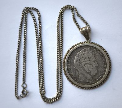 a close up of a coin on a chain with a chain around it