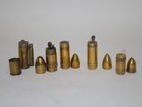 a lot of brass bullet shells on a white surface