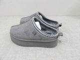 grey sued slippers with zippers on the side of them on a white surface