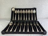 a lot of spoons and forks in a black case