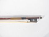 a close up of a violin bow on a white surface
