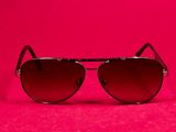 a pair of sunglasses on a pink background