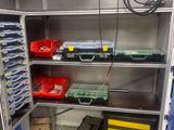 a metal shelving with lots of tools in it