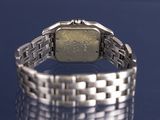 a silver watch that is sitting on a table