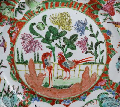 une assiette colorée ornée d'un oiseau et de fleurs