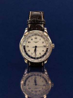 a close up of a wrist watch on a reflective surface