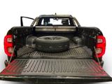 an image of a truck with a tire in the bed
