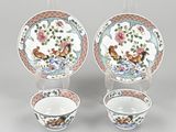 three pieces of chinese porcelain on a stand and two cups and saucers