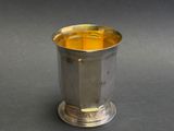 a silver cup that is sitting on a table