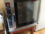 a microwave that is sitting on a stand in the kitchen