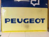 a sign that says peugeot on the side of a building