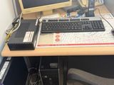 a computer desk with a keyboard and a monitor on it