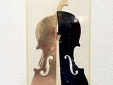 a sculpture of a violin and a violin case on a table