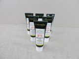 quatre tubes de dentifrice posés sur une table