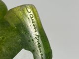 a green bottle with a label on it