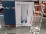 a glass of water sitting on a table next to a box