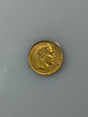a close up of a gold coin on a white surface