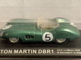 a green model of a racing car in a display case