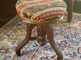 a small stool sitting on a rug in a room