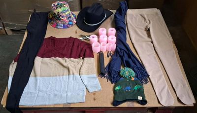 a table with a hat, scarf, gloves, and other items on it