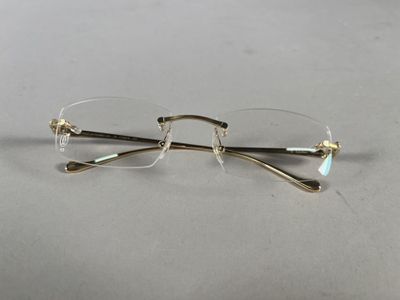 pair of glasses on a table with a white background