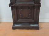 a wooden cabinet with a clock on top of it