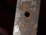 a close up of a knife with a gold handle