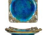 a blue plate and a gold plate on a stand