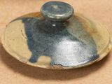 a small bowl with a lid that has a cat on it