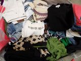 a suitcase full of clothes and clothes sitting on the floor