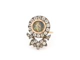 un gros plan d'une bague en diamant et en or sur fond blanc